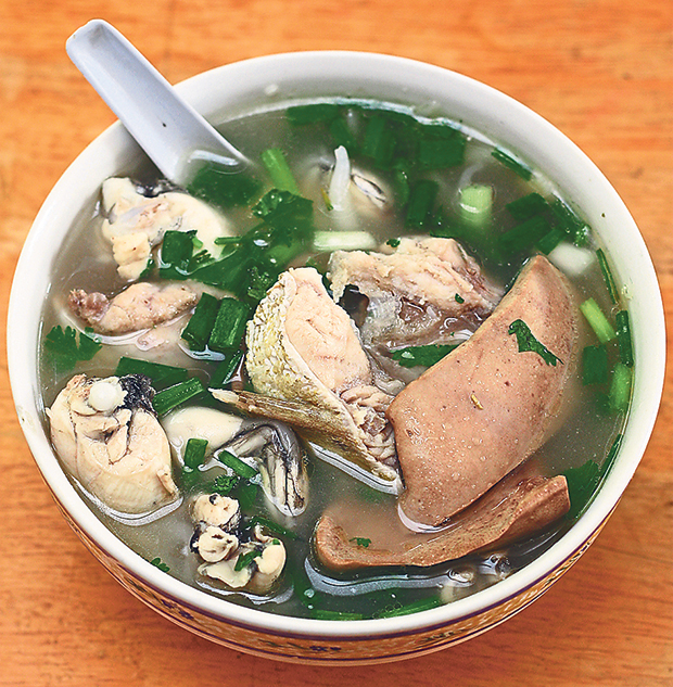 Ring Road Restaurant allows you to customise your own bowl of noodles, like this one with fish head, frog legs and pork kidney slices