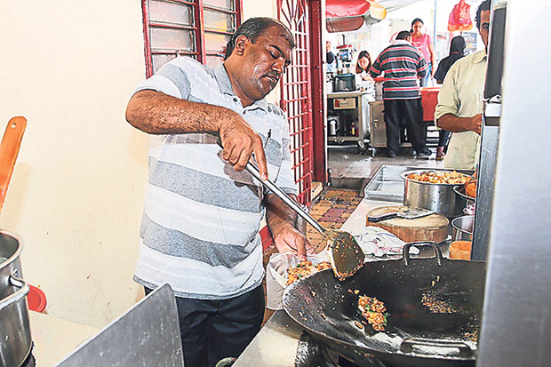 Zabar Ali fries up the delicious noodles.