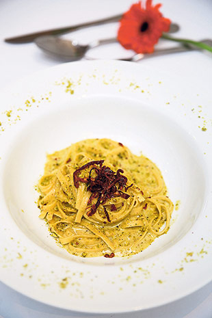 The classic carbonara pasta is given a beautiful twist with pistachios and sundried tomatoes.