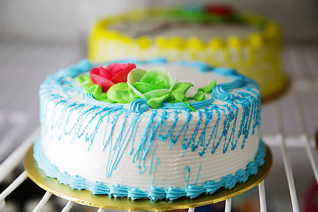 Old school cakes topped with icing and wafer roses.