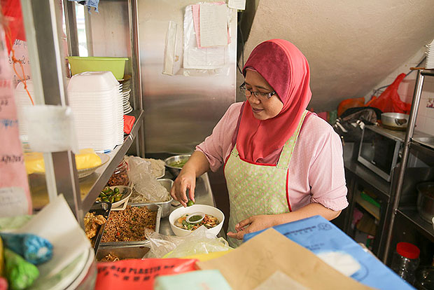 Rumuni binti Marjonad prepares the meehoon soup for Friday's lunch.