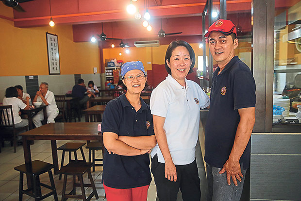 At Moon Kee’s Section 17 outlet, Chai Huey Mun (middle) runs the place with her brother Chai Ken Kok (right) and his wife Leong Shwu Shyan (left).