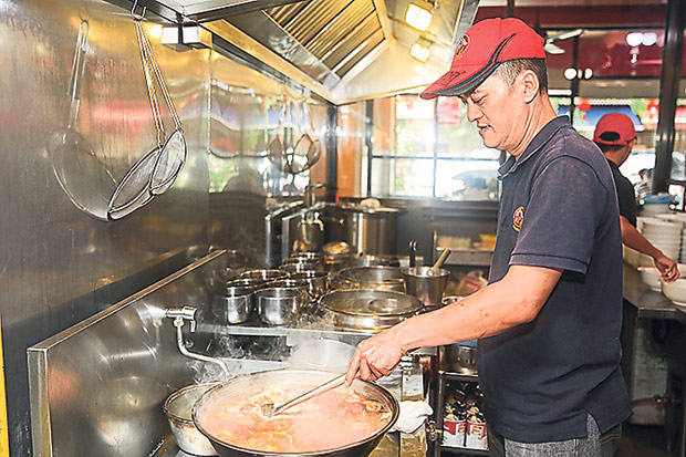 Chai Ken Kok behind the stove at Moon Kee.