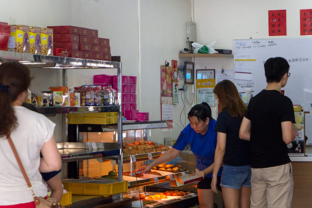 The staff at Yuen Fatt Biskut will help you select your choice of mooncakes.