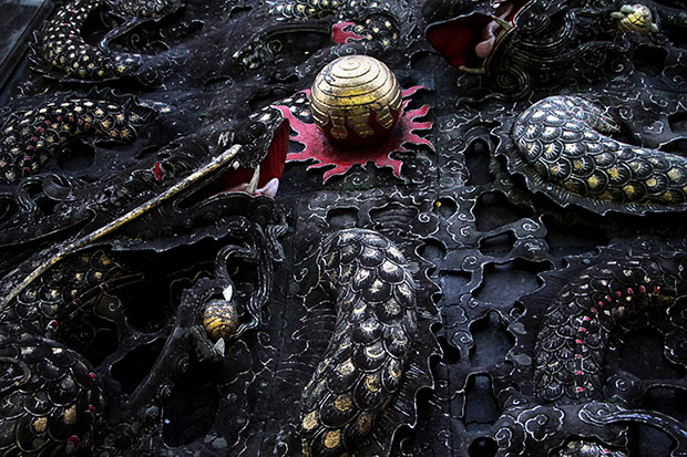 Close-up of ornate temple art featuring a Chinese dragon.