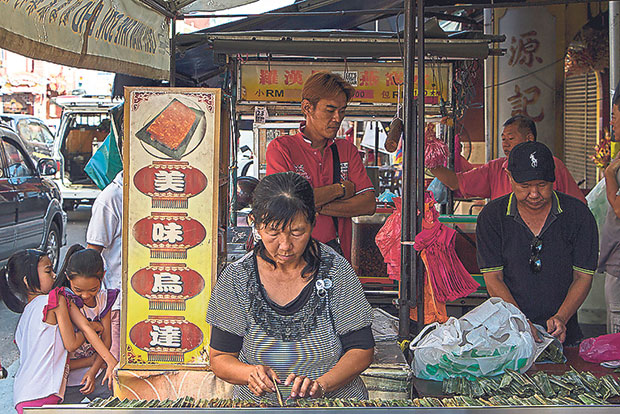 Stacks of takeaway curry rice being prepared by Mrs. Wee.