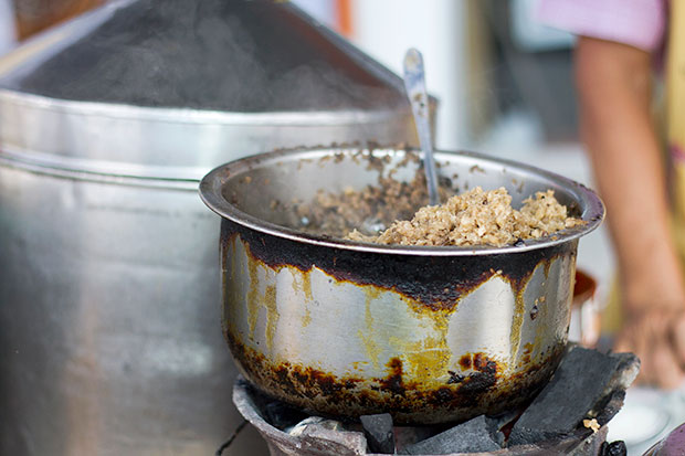 A charcoal stove is used to keep the chye poh mixture simmering hot.