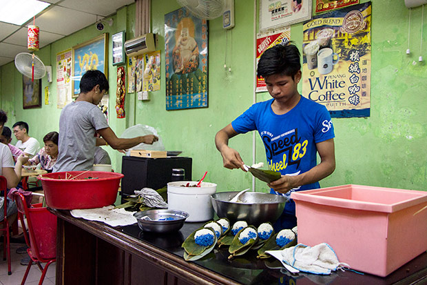 Workers busy making dozens of Nyonya chang.