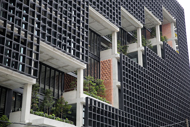 A diagonal stack of atriums opens selected floors to pockets of planted trees.
