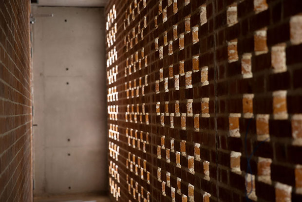 A wall of exposed raw brick adds texture to the interior.