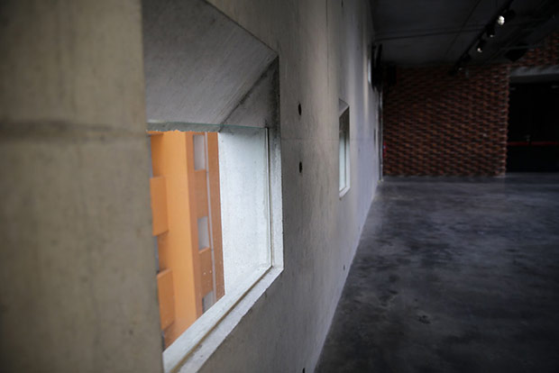 The shear wall has a number of square holes and windows for ventilation.