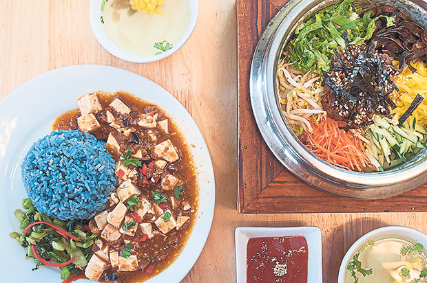 Seed Natural Food Cafe’s blue pea flower tinged rice with sour and spicy ma po tofu on the left and stone pot rice on the right.