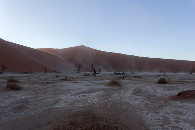 Surreal vision of bone-white dust rising from the Deadvlei pan.