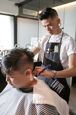 Tan is always focused when cutting a client’s hair.