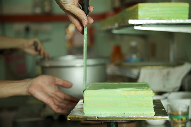 It takes a deft hand to lay the special filling over the cake before it coagulates.