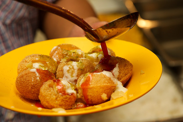 Tamarind chutney is added over the pani puri.