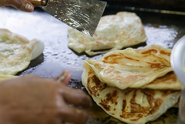 Azizah Awang learned how to make roti canai from her husband.