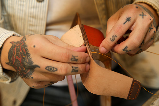 Deft hands making leather masterpieces.