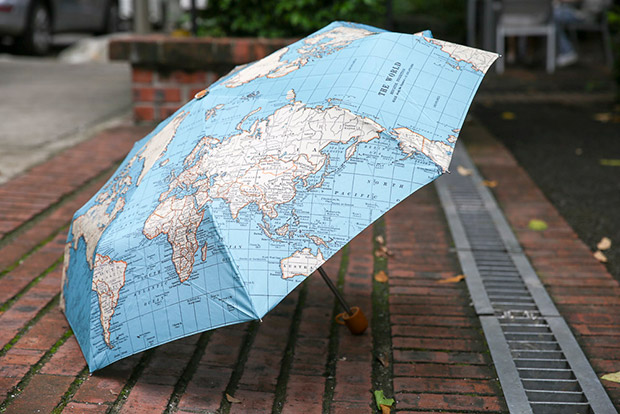 Stay dry with this vintage world map folding umbrella.