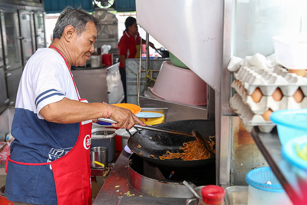 The secret behind each plate of fried noodles is Alex's exemplary skills in handling the hot wok.