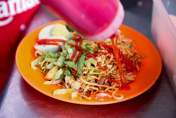 Tomato sauce is drizzled over the noodles.
