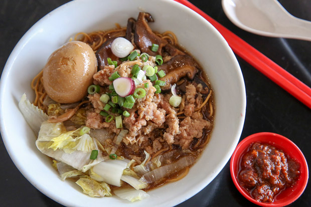Slurp up the Signature Mushroom Pork Noodles with sambal on the side.