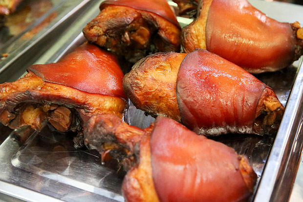 The smoked pork knuckle goes through a long process of curing, slow cooking and smoking before it is served.