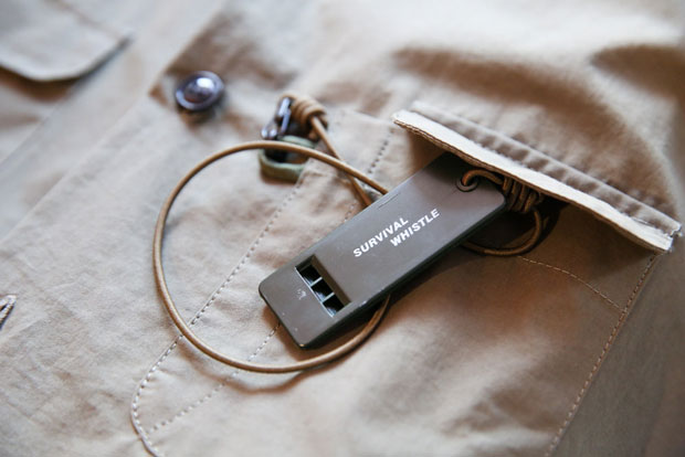 A shirt from their Portraits in Olive collection comes fitted with a survival whistle.