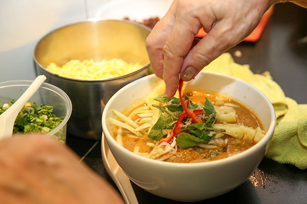 Adding the final touches to the laksa lemak