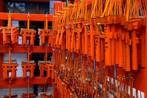 Prayers written on tiny torii gates.