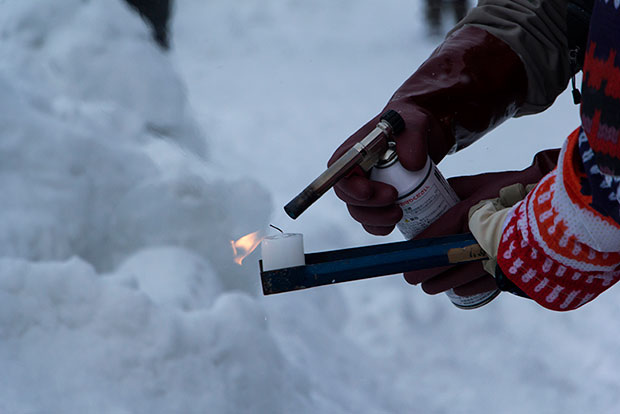 Relighting candles with a blow torch
