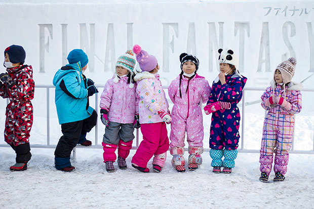 Children in front of the Final Fantasy XIV Battle of Winter Wonderland.