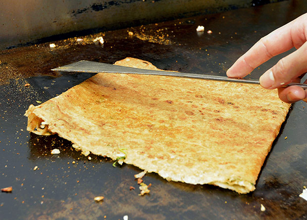 Once it is evenly brown, the onion dosa is ready to be served.