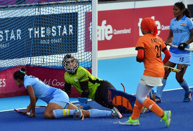 Indiau00e2u20acu2122s Rani (left) scores a goal as Malaysiau00e2u20acu2122s goalkeeper Farah Yahya (2nd left) looks on during their womenu00e2u20acu2122s field hockey match at the 2018 Gold Coast Commonwealth Games in Gold Coast, Australia April 6, 2018. u00e2u20acu201d AFP pic