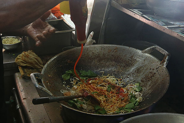 Saleem insists on frying every plate of mee goreng himself