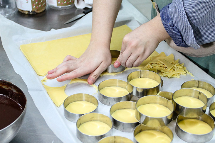 Rachel patiently cuts the buttery pastry for their tarts.