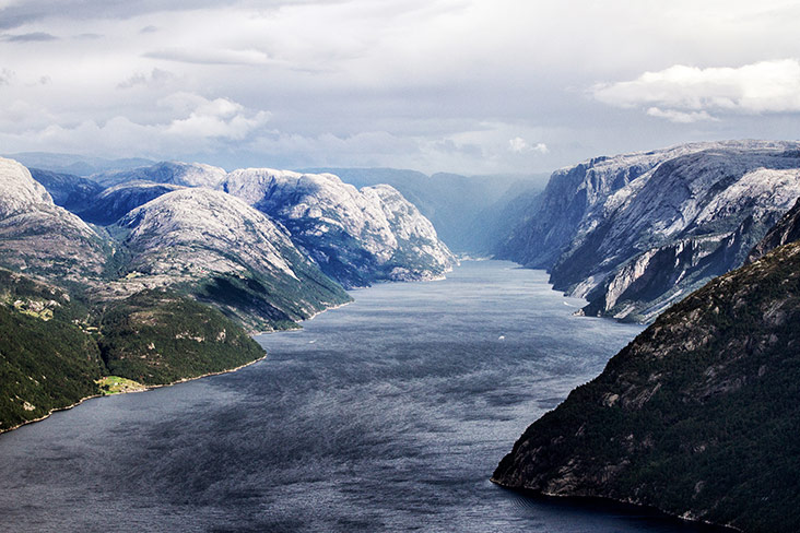 Snow-capped peaks on both banks of the fjord.