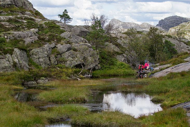 Taking a break next to a pond.