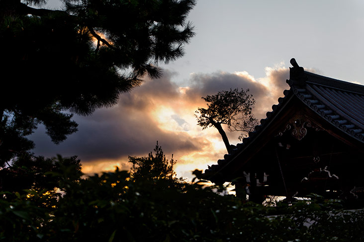 Silhouette of ichimonji roofs as the sun sets.