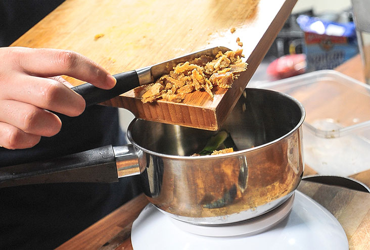 The gula Melaka is chopped and boiled to make a sauce for the som som