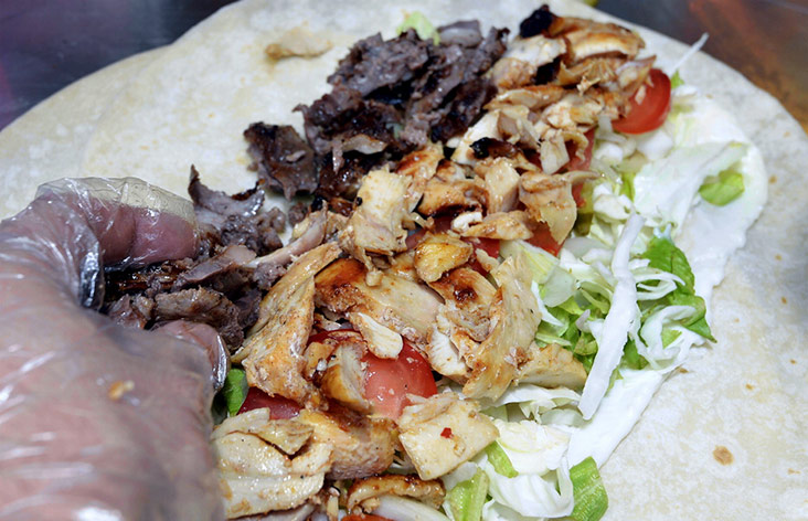 The Shawarma King is one hefty bite with 500 grams of chicken and lamb shawarma and vegetables on Turkish bread.