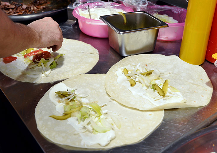 Adding the pickles and vegetables.