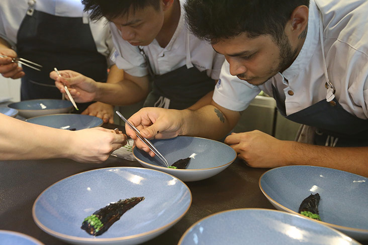 It takes a lot of patience to slowly dot each small petai belalang to create the ‘stalk’ for the eggplant.