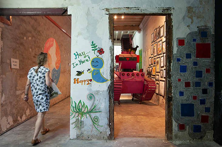 A visitor catches a glimpse of the Pink Tank, a striking installation that once greeted visitors at 179 Lebuh Victoria, an antique store that is also owned by China House