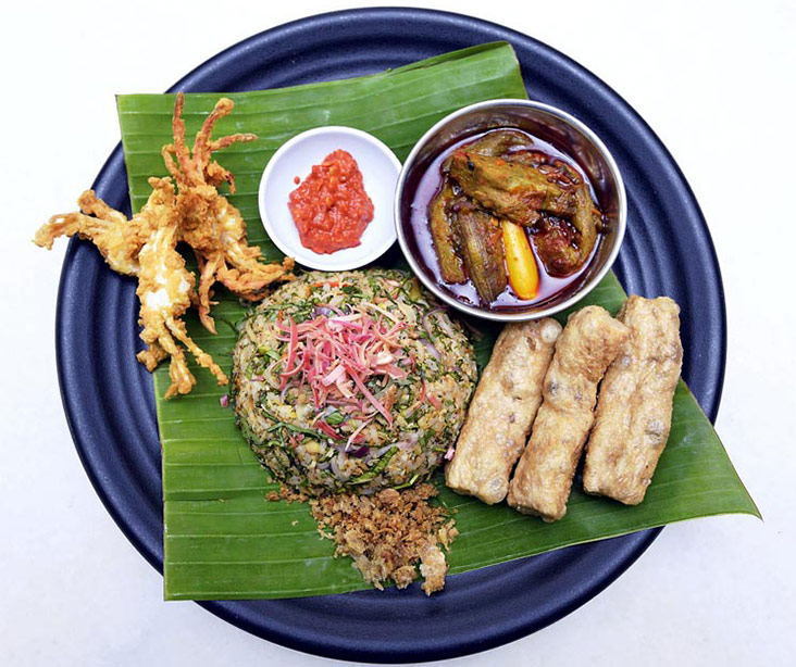 The nasi ulam is served with wild yam stems, salted fish, keropok lekor and fried baby crabs.