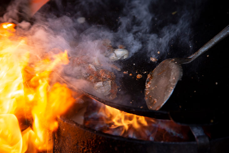 Oysters are stir fried with garlic before being added to the concoction.