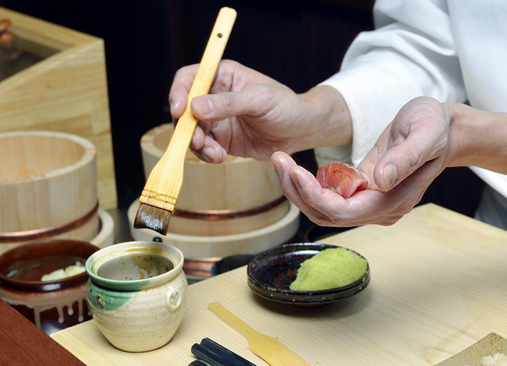 Just before serving, the chutoro sushi is brushed with its sauce.