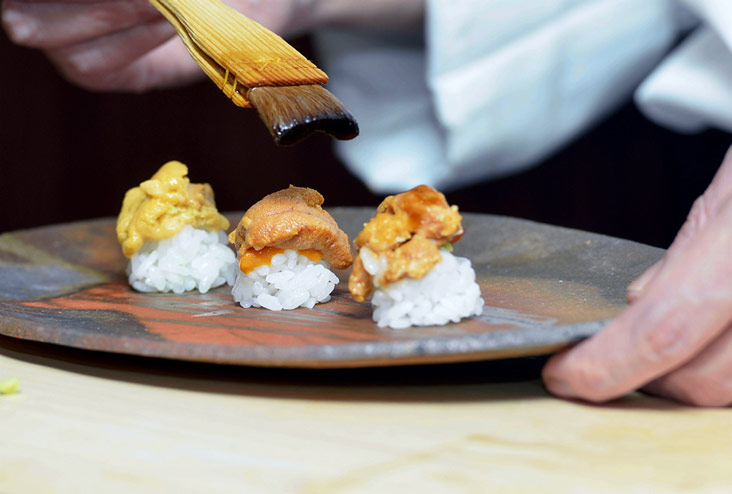 The magnificent uni tasting flight with two types of uni from Hokkaido and another one soured in Amakusa.