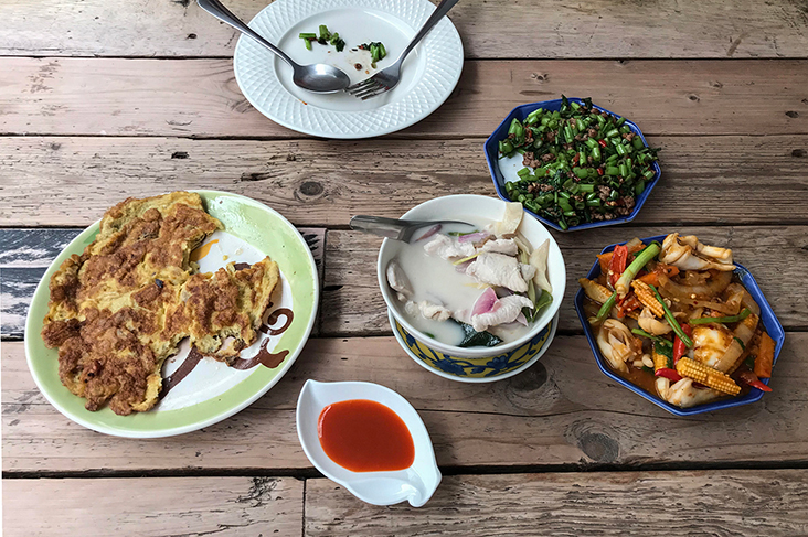 A balanced home-cooked meal: khai jiao (Thai-style omelette), tom kha gai (chicken coconut soup), moo sub pad numleab (morning glory with Chinese black olives) and humk pad kai kem (squid with salted egg yolk)
