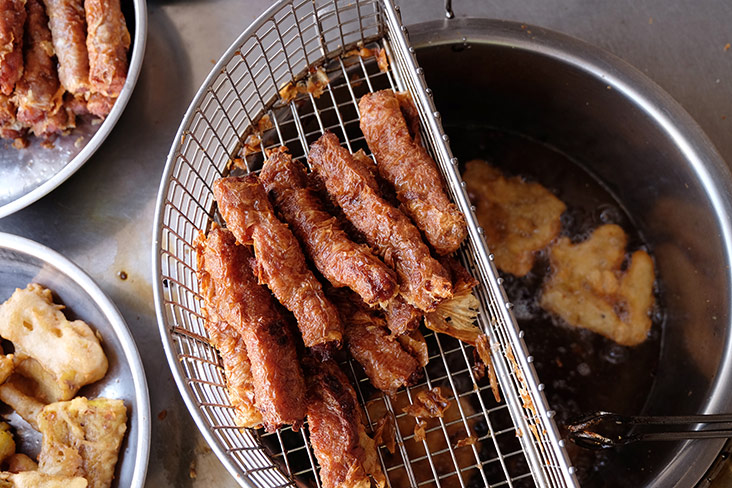 The frying up of lor bak and prawn fritters at the stall.